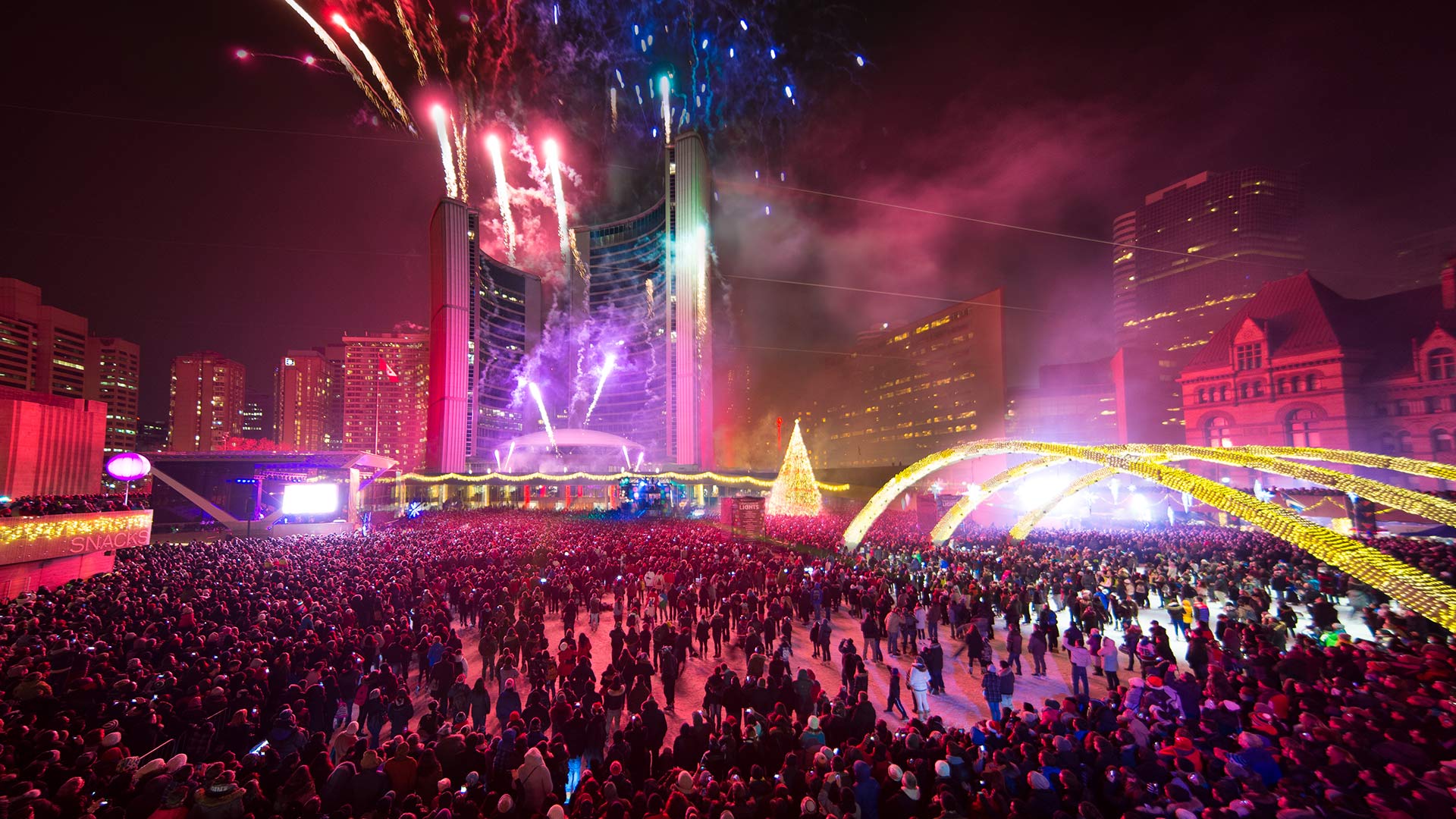 People watch the Christmas lights and fireworks at the Nathan Phillips Square in Toronto on November 30, 2013 (© Canadapanda/Shutterstock)